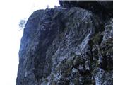 Žakeljnov bivak na Stebrasti skali Mežakle pot ki zahteva plazenje po polici (zadaj je vidna Stebrasta Skala na kateri stoji bivak)